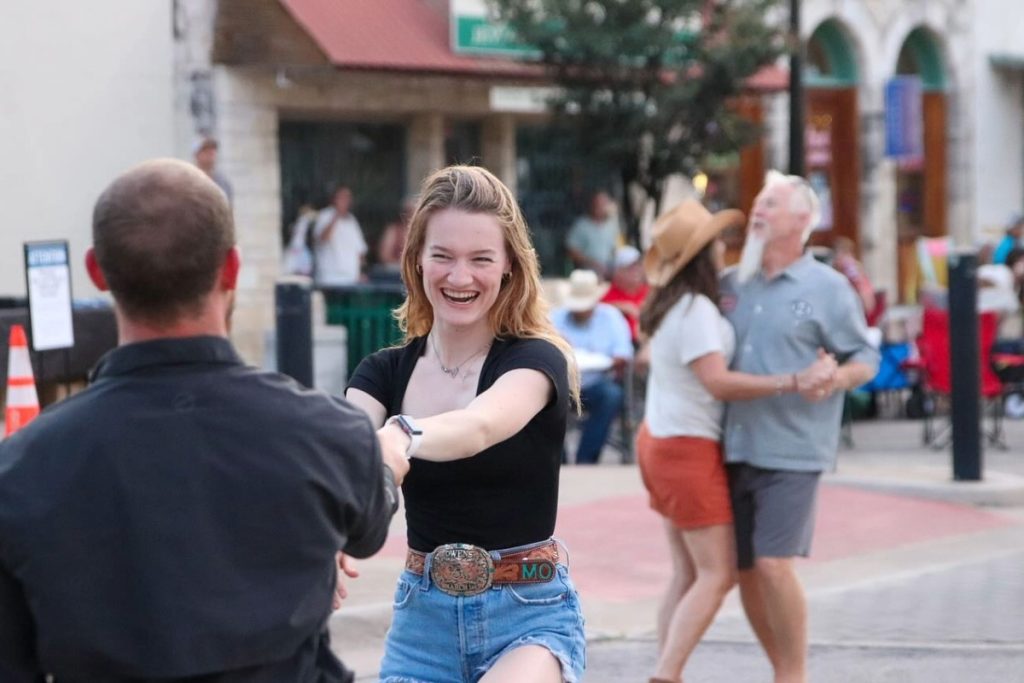 Couples dancing at a Jackson Street Jams concert in Burnet