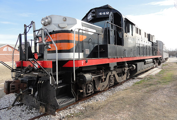 steam train called the Hill Country Flyer black train engine with a red stripe