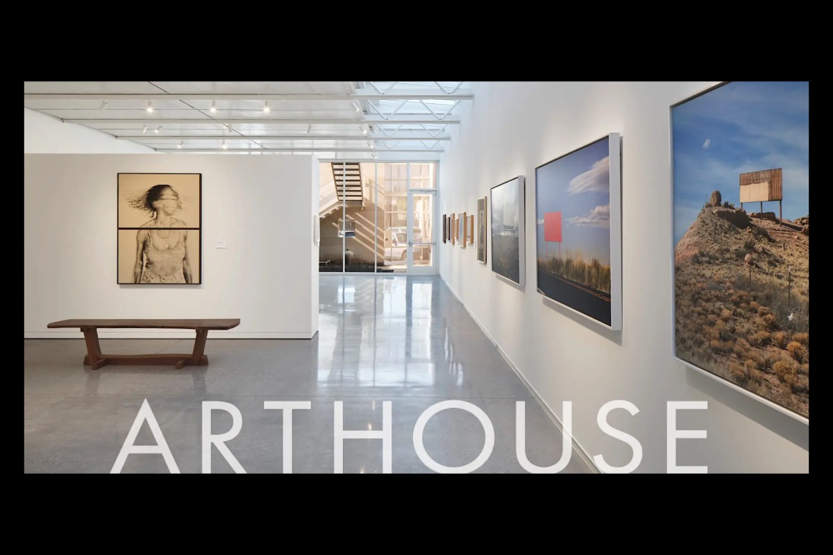 A modern art gallery with white walls, various framed artworks, a wooden bench, and a staircase in the background. The word ARTHOUSE is overlaid at the bottom of the image.