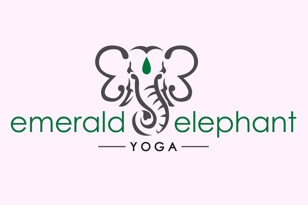 Logo for Emerald Elephant Yoga, featuring a stylized gray elephant head with a green teardrop gem on its forehead, and the text emerald elephant YOGA—perfect inspiration for a relaxing Girls Weekend or 3 Day Itinerary in Burnet County.