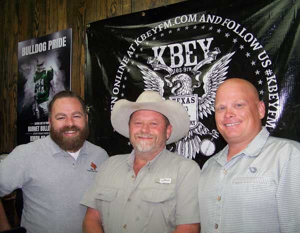 Jason Jamar (left), Brent Nichols, and Damon Beierle talk about the Burnet County Rodeo.