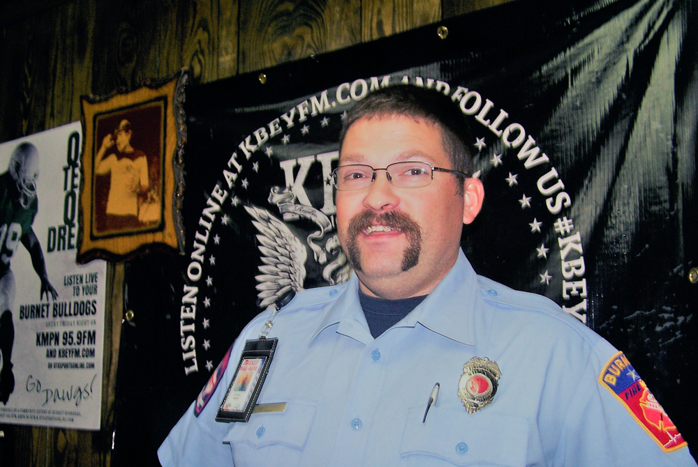 Burnet firefighter David Lackey talks about the Back-to-School Bonanza in Burnet on Aug. 18.