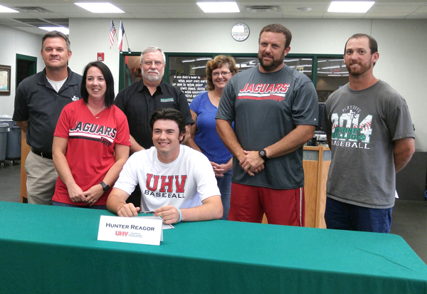 Burnet High School senior pitcher Hunter Reagor (seated) signed to play baseball for the University of Houston at Victoria on May 26 as Burnet head baseball coach Todd Doucet (standing, left), mother Codi Reagor, grandfather Ken Reagor, grandmother Rhoda Schmidt, father Zachary Reagor and Burnet assistant baseball coach Steven Shipley looked on. Staff photo by Jennifer Fierro