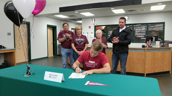 Burnet High School senior Brock Foster signs his letter of intent to be a track-and-field athlete for McMurry University as parents Earl (standing, left) and Kaci, grandmother Liz White and brother Chadd Foster look on. Staff photo by Jennifer Fierro