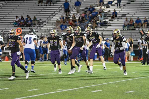 Marble Falls senior linebacker Heath Dooley is pumped after he gets an interception. Celebrating with him are junior linebacker Santiago Castillo (42), sophomore linebacker Zach Fearn (54), senior defensive lineman Dawson Atwood (57), senior defensive back Chris Yun (21) and senior linebacker Jonathan Bryer (44). Photo by Diana Cox