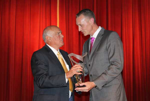 Former University of Texas-San Antonio and University of Houston athletics director Rudy Davalos (left) accepts the Lamar Hunt Lifetime Achievement award from Jared Mosley, president and chief executive officer of the Texas Sports Hall of Fame. Staff photos by Jennifer Fierro
