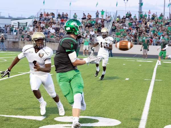 Burnet’s Drew Kiser keeps his eye on the ball even as an Austin Crockett Cougar moves in for a hit. Kiser and the Bulldogs beat Crockett 44-18 on Sept. 17 at Bulldog Field and improved to 4-0. The Bulldogs travel to Llano on Sept. 23 to take on the Yellow Jackets with a 7:30 p.m. kickoff. Listen to the game on KMPN 95.9 FM powered by KBEY or at KBEYFM.com starting with a 7 p.m. pregame. Photo by Glenn Morris/FTMOG.com