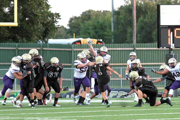 The Marble Falls High School football team blocked a field goal attempt by Austin Crockett during the first half of the Mustangs’ 44-21 win on Sept. 9. Photos by Diana Cox