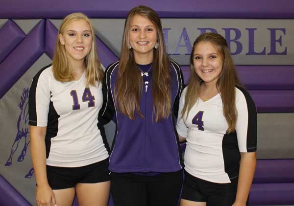 Marble Falls High School freshman volleyball coach Allison Bendas (middle) returns to her alma mater to pass along her knowledge of the sport to players, including Faith McRee (left) and Alysa Clawson. Staff photo by Jennifer Fierro