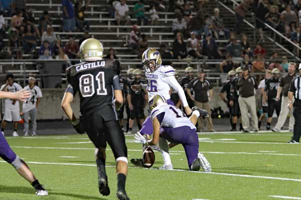Marble Falls senior kicker Gavino Tinajera connects on a 29-yard field goal against Austin Crockett with the help of junior holder Nick Veloz during the Mustangs’ 37-21 win Sept. 9. Photo by Diana Cox
