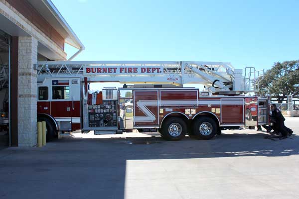 The Burnet Fire Department firefighters push Quint 1, the city’s ladder truck, into the firehouse bay at 2002 U.S. 281 in Burnet during a ceremony Nov. 30. The push-in ceremony was a first for the city. Attendees were from the city of Burnet, the Burnet Economic Development Corp., the Emergency Services District 1, and the Burnet Rotary Club. Staff photo by Jennifer Fierro
