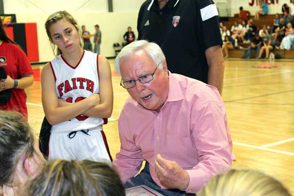 Faith Academy of Marble Falls head girls basketball coach Jerry English talks to the Lady Flames during halftime of their 61-23 victory over Waco Reicher on Nov. 15 — his 1,197th career win. He followed that victory up a few games later with his 1200th win, which was one for the record books. The school will celebrate his milestone at 6:30 p.m. Tuesday, Nov. 22, at the student center on campus, 3151 RR 1411 East in Marble Falls. Staff photo by Jennifer Fierro