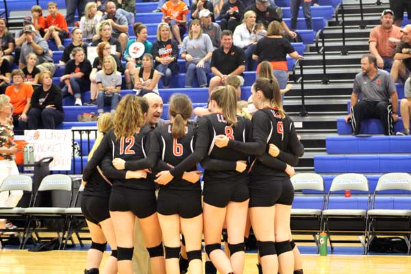 Llano High School head volleyball coach John Black talks to his players during a timeout.
