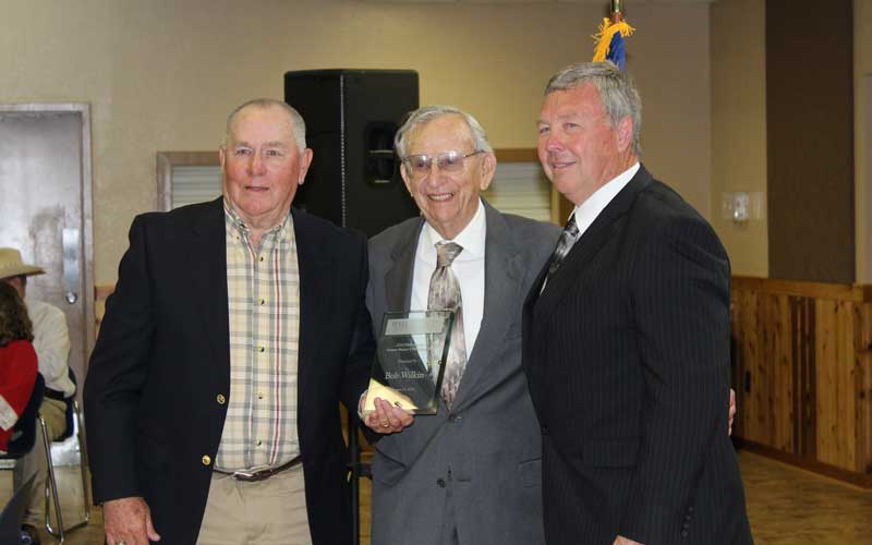 Burnet Consolidated Independent School District board members Charles Williams (left) and Craig Barefoot (right) welcome former BCISD Superintendent Bob Wilkin to the school district’s 2016 Hall of Fame as a Distinguished Former Employee. File photo
