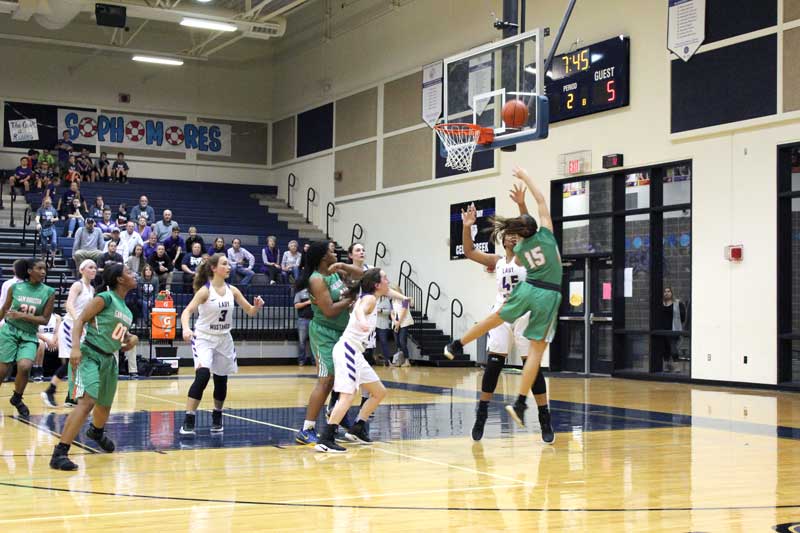 Marble Falls High School sophomore post Trinity Boyd forces San Antonio Sam Houston junior forward Rosalie Hansen to take an awkward shot during the first quarter of the area championship Feb. 17. Marble Falls won 57-47. Staff photo by Jennifer Fierro