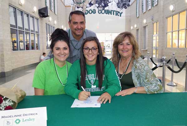Burnet High School senior soccer player Madelinne Deitrick (seated, center) signs her letter of intent to play for Lesley University in Cambridge, Massachusetts, surrounded by sister Alex (seated, left) mother Marianna McNamara, and father Steve Deitrick. Staff photo by Jennifer Fierro