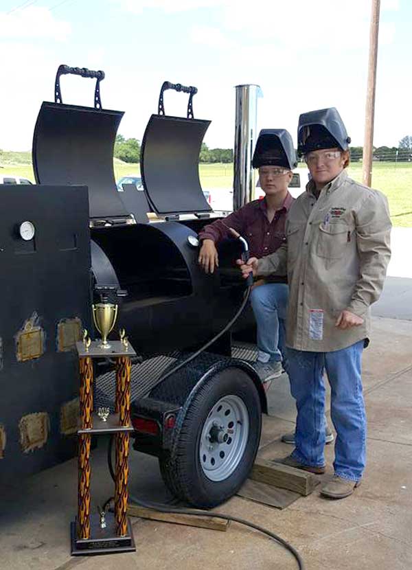 Clint Ringstaff (left) and Ryan Warwick are two of the Burnet High School students who helped build a barbecue pit this year on which culinary arts students will cook during the 2017 State of Texas High School Barbecue Cook-off on Saturday, April 29, at the high school, 1000 The Green Mile. Courtesy photo