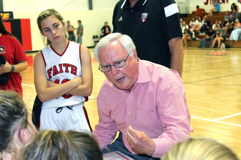 Former Faith Academy of Marble Falls girls basketball coach Jerry English speaks with his players during a game. Staff photo by Jennifer Fierro