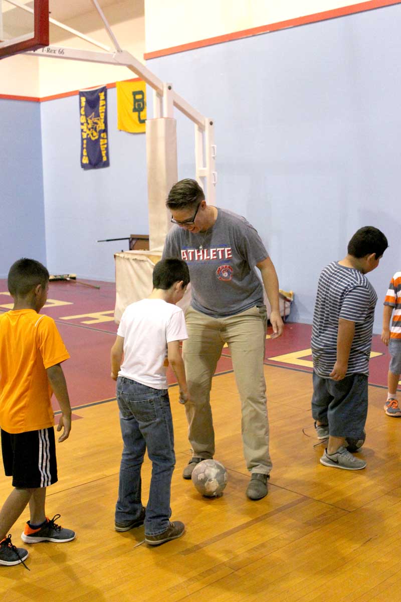 New Boys & Girls Club of the Highland Lakes-Marble Falls unit director Victoria Rucker plays soccer with a couple of the members. Staff photo by Jennifer Fierro