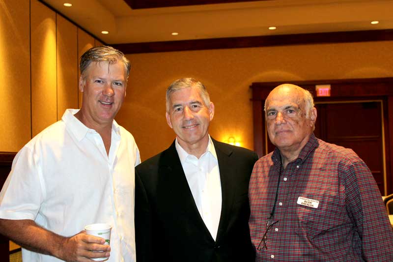 Horseshoe Bay Sports Club members Brad Goebel (left) and Rudy Davalos (right) welcome Big 12 Conference Commissioner Bob Bowlsby as the group's featured speaker May 9. Staff photo by Jennifer Fierro