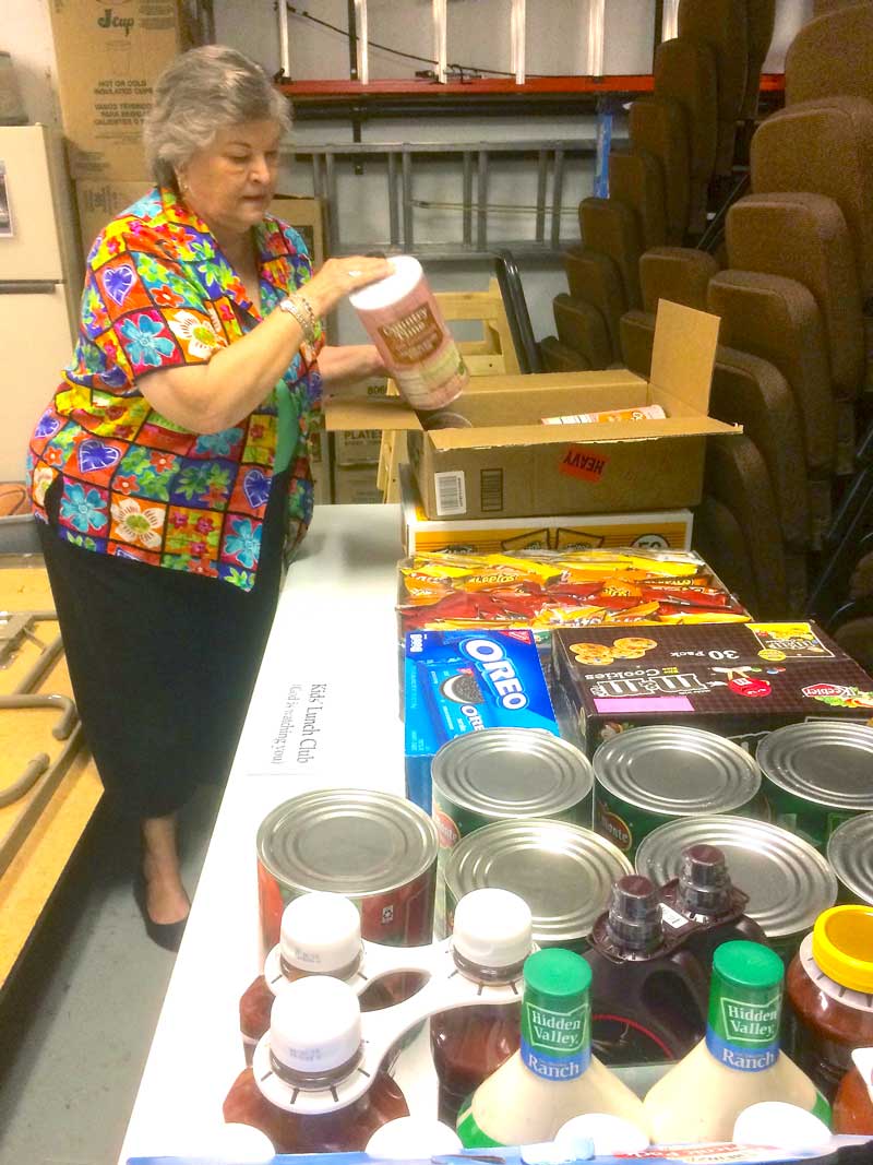 Volunteer cook Ann Godwin unpacks some of the food stocked for the Kids’ Lunch Club, which provides free lunches for children three days a week through June and July. Lunch is served every Monday, Wednesday, and Friday through July 28 at First United Methodist Church in Johnson City. Courtesy photo