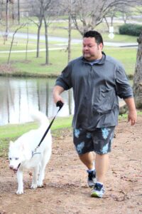 Chris Garza and his dog, Enu, walk the hike-and-bike trail linking Johnson and Westside parks in Marble Falls. Staff photo by Jennifer Fierro
