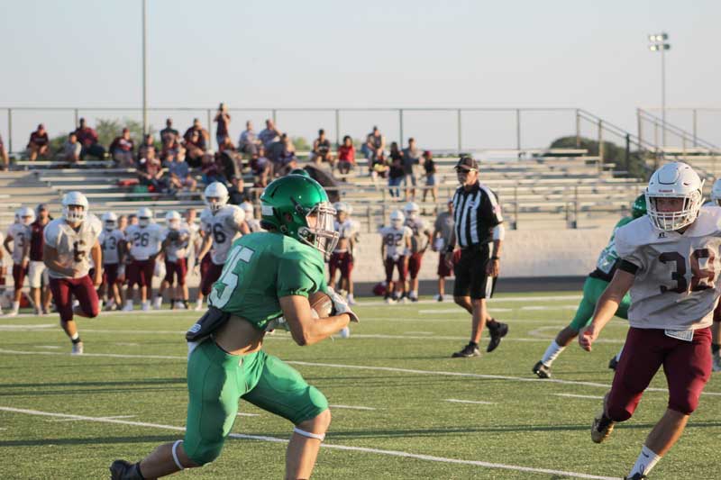 Burnet High School junior running back Ryan Jackson looks for a path to the end zone during a scrimmage against Brownwood on Aug. 18. The Bulldogs open their season Thursday, Aug. 31, against Reagan High School at Nelson Field in Austin. Staff photo by Jennifer Fierro