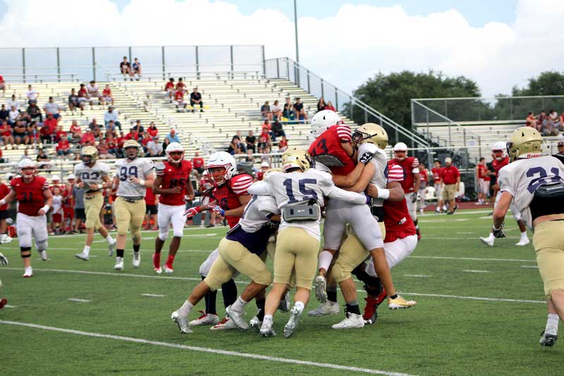 The Marble Falls High School football team’s starting defense swarms to a Georgetown East View receiver during an Aug. 25 scrimmage between the two squads. The Mustangs open their season against Bastrop Cedar Creek at 7:30 p.m. Friday, Sept. 1, at Bastrop Memorial Stadium, 755 Texas 21 West in Cedar Creek. Staff photo by Jennifer Fierro