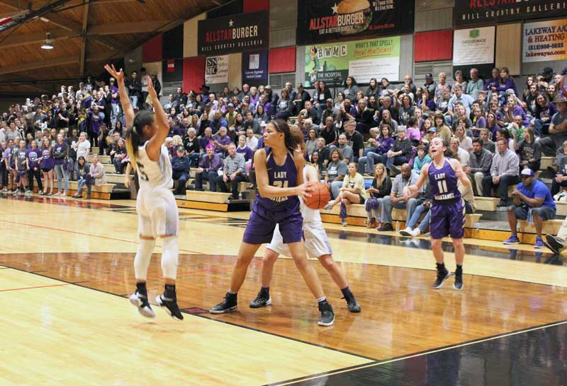 Marble Falls High School post Mya McMillian (center) commited to playing basketball for Liberty University in Virginia. File photo