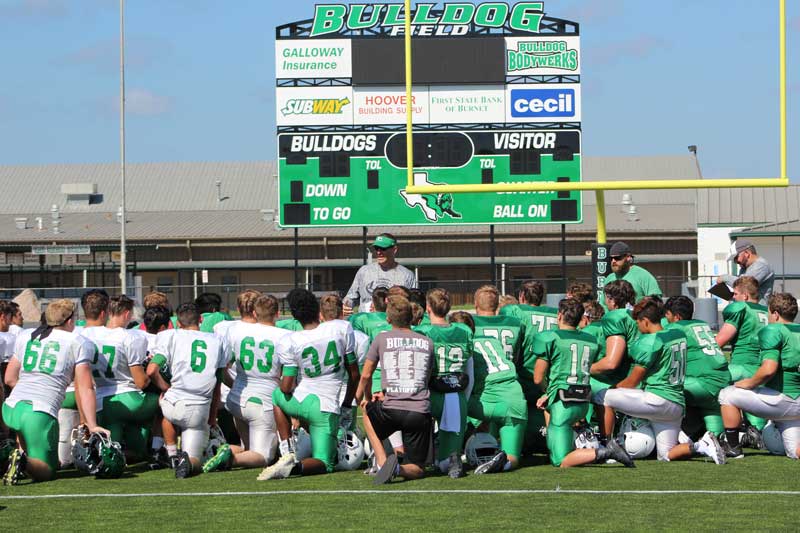 Burnet High School head football coach Kurt Jones talks to his Bulldogs following a practice. Staff photo by Jennifer Fierro