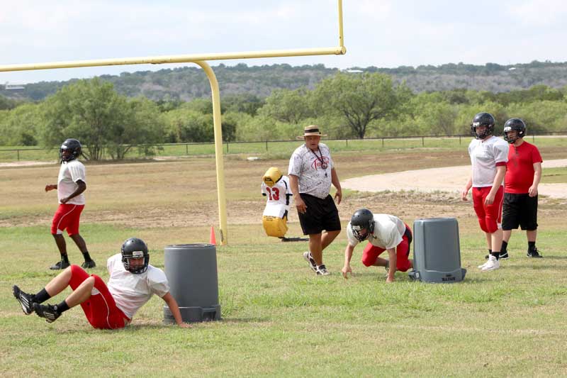 Faith Academy of Marble Falls head football coach Pete Rhoades says practices are filled with fundamentals so those skills become second nature to the Flames. Staff photo by Jennifer Fierro