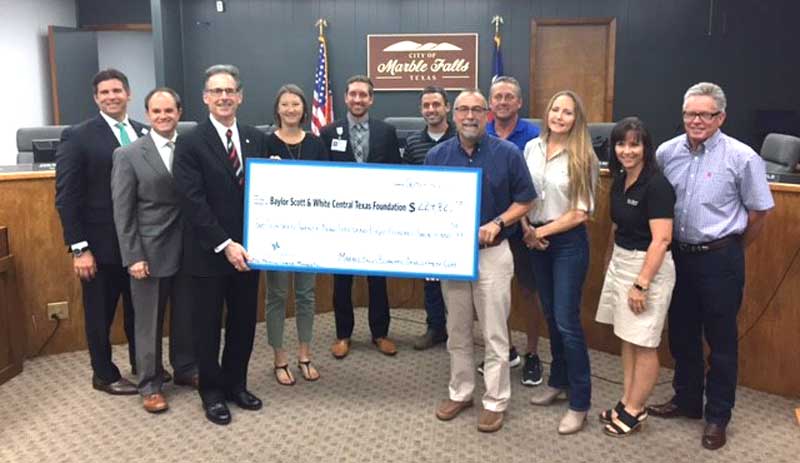 Baylor Scott & White Medical Center-Marble Falls received a reimbursement check Sept. 6 from the Marble Falls Economic Development Corp. for meeting jobs creation goals. Pictured are Baylor Scott & White CEO Hill Country Region Bramer Owens, Marble Falls EDC Executive Director Christian Fletcher, and EDC board members Lindsay Plante, hospital foundation development officer Chris Beck, Ryan Nash, Mayor John Packer, Jane Marie Hurst, Judy Miller, and Mark Mayfield; Scott & White Hill Country Region President Tim Ols (front, left), and EDC board member Steve Reitz. Courtesy photo