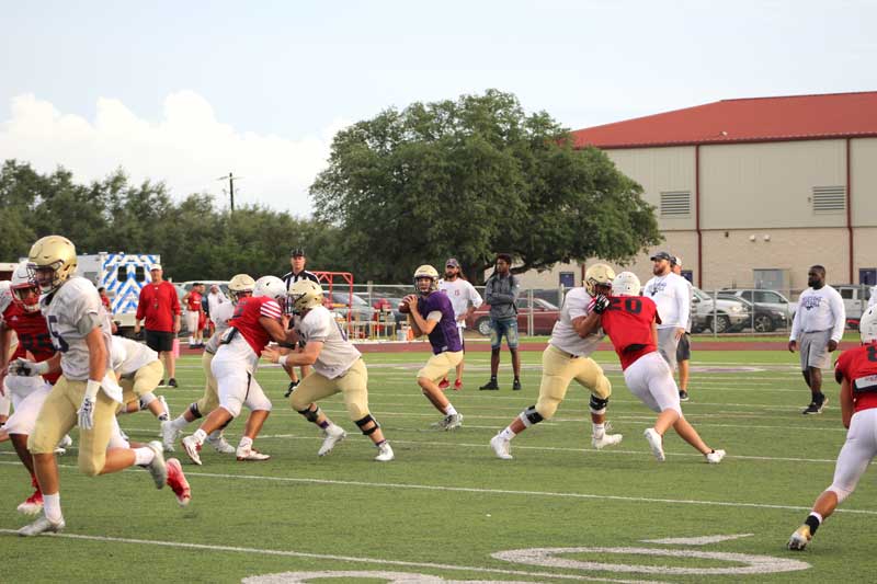 Marble Falls High School junior quarterback Andrew Stripling scans the field to look for an open receiver during a scrimmage against Georgetown East View on Aug. 25. The Mustangs open the season against Bastrop Cedar Creek at noon Saturday, Sept. 2, at Bastrop Memorial Stadium, 755 Texas 21 West in Cedar Creek. Listen to the game on KBEY 103.9 FM Radio Picayune or at KBEYFM.com. Staff photo by Jennifer Fierro