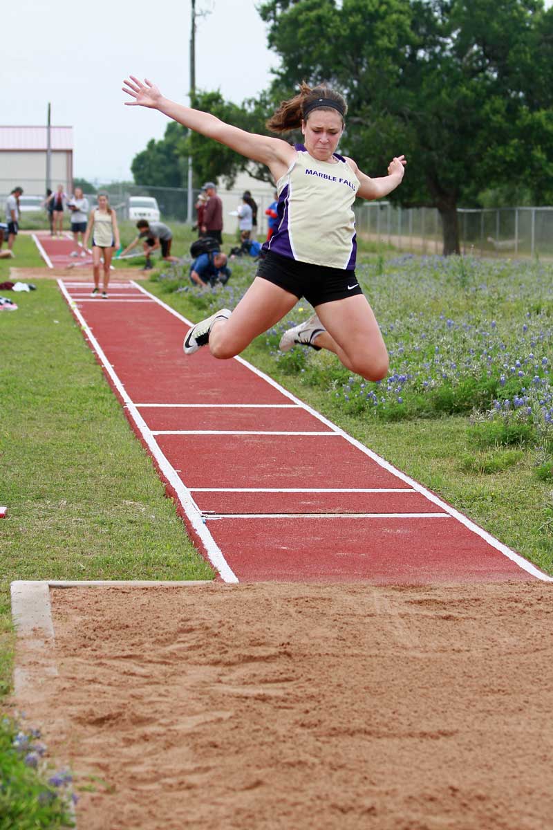 Lauren Loader competes in the long jump for Marble Falls High School during the District 25-4A track meet in 2015 just before a foot injury sidelined her for two years. She recently made the University of Texas at Austin track-and-field team as a javelin thrower. Staff photo by Jennifer Fierro