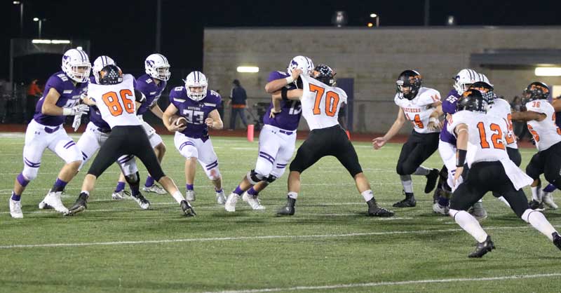 Marble Falls junior running back Cooper Wilson runs through a hole crated by junior receiver Brock Linder (80), senior lineman Jervon Collins, senior lineman Alec Oberle, and junior lineman Chance Haley (55) during the Mustangs’ 50-30 loss to Castroville Medina Valley on Sept. 29. After a bye this week, Marble Falls continues District 26-5A play on Oct. 13 against Boerne Champion. Photo by Luedecke Photography
