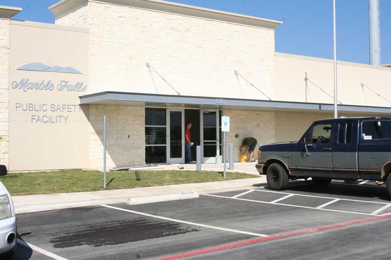Jason Tom (left) and Michael Osborne of Net Solutions work to install the internet system Nov. 2 at the new Marble Falls Public Safety Facility, 606 Ave. N. Staff photo by Connie Swinney