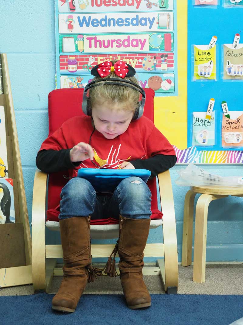 Kingsland School student Preslie Watson works on her reading in Jan Woods’s kindergarten class. The charter school students have access to much of the same technology their traditional public school counterparts have. The Kingsland School, which opened in August 2016, must follow state and Texas Education Agency rules and guidelines. Staff photo by Daniel Clifton