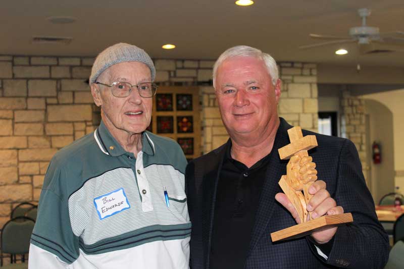 Wood-carving master Bill Edwards (left) presents former college football coach Dennis Franchione with a 'Hand-Held Cross.' Edwards created the piece and gives one to each speaker of the Men of Faith gathering. Franchione was the guest speaker during the Jan. 9 gathering. Staff photo by Jennifer Fierro