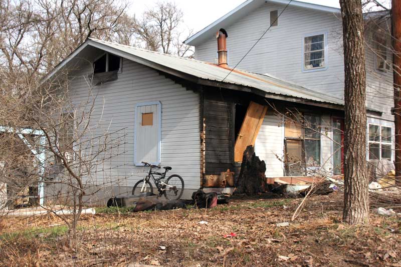 Fire officials believe a cigarette smoldering in a tree stump adjacent to a house might have ignited a fire Jan. 31 in the 1400 block of Kings Hill Drive in Granite Shoals. Staff photo by Connie Swinney
