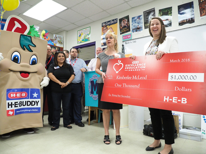 Marble Falls High School teacher Kimberlee McLeod (right) smiles as H-E-B public affairs manager Jill Reynolds tells her and her students that H-E-B has selected McLeod as a finalist for the Rising Star Secondary honor. As a finalist from the Central Texas region, McLeod and the high school each receive a $1,000 check. She’ll now compete May 5-6 in Houston for statewide honors. Staff photo by Daniel Clifton