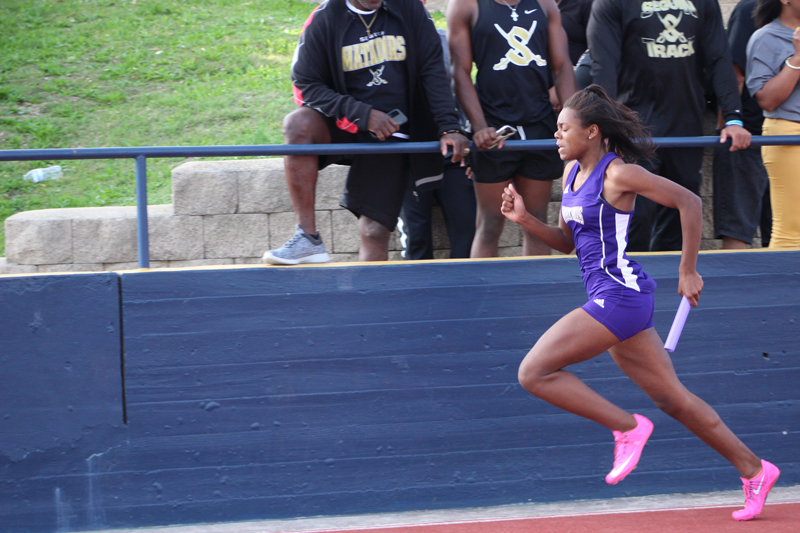Sophomore runner Alexis Torns hugs the curve during the 4x200-meter relay during the District 26-5A meet April 5 before giving the baton to senior Trinity Ware. Torns and her teammates all advanced to the Class 5A Region IV after their finishes in the District 25 and 26-5A area meet April 19. File photo