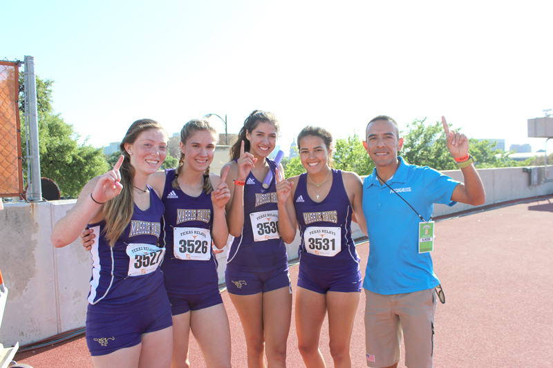 The Marble Falls High School 1600-meter sprint medley team of junior Nomi Pegues (left), freshman Bailey Goggans, junior Natasha Villalobos, and senior Trinity Ware pose with three-time U.S. Olympian Leonel Manzano, a 2004 graduate of Marble Falls. Staff photo by Jennifer Fierro