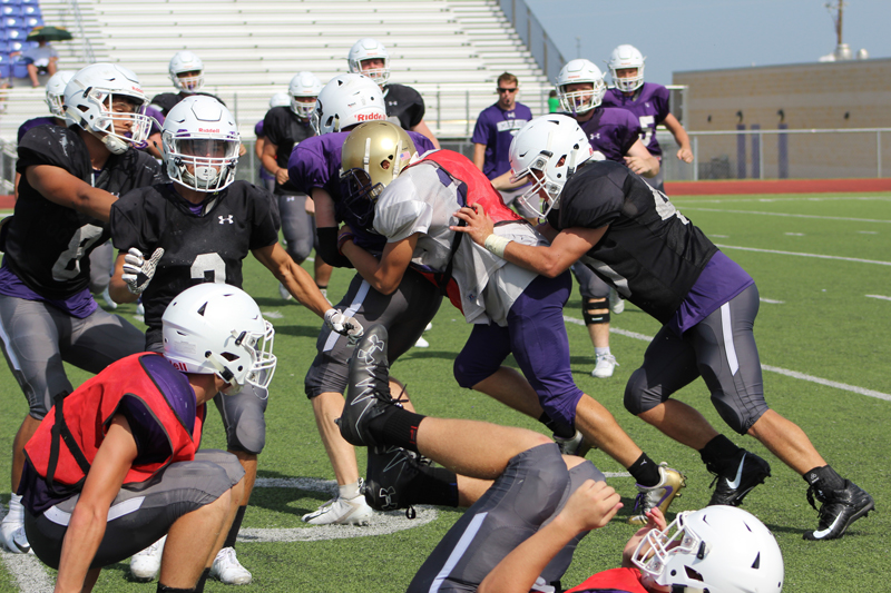 Marble Falls High School junior running back Hayden Wells fought for every inch during the Mustangs’ scrimmage Aug. 18. Staff photo by Jennifer Fierro