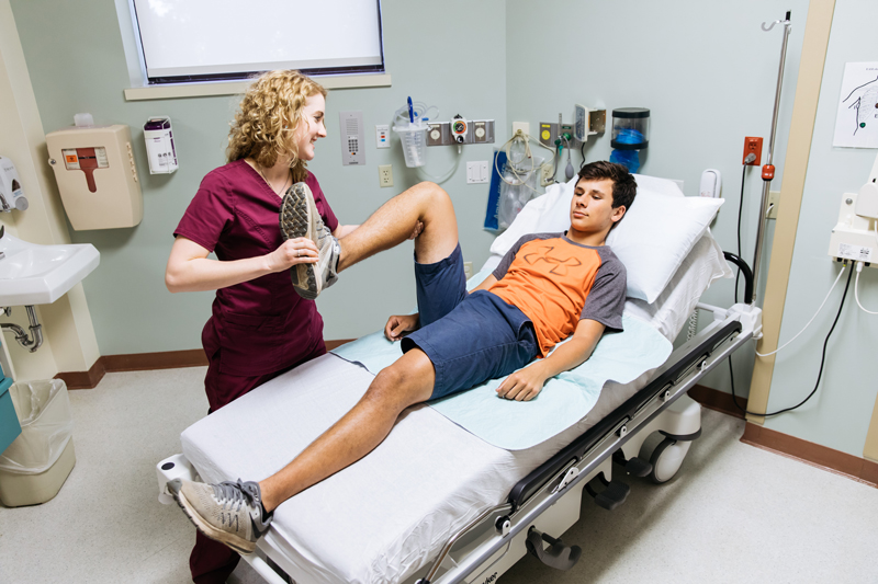 Hill Country Memorial physical therapist Ginny Brown examines high school student Joel Jenschke’s knee. The Fredericksburg hospital is offer free orthopedic and physical therapy evaluations to middle and high school students on Saturdays from Aug. 18-Nov. 10. Courtesy photo
