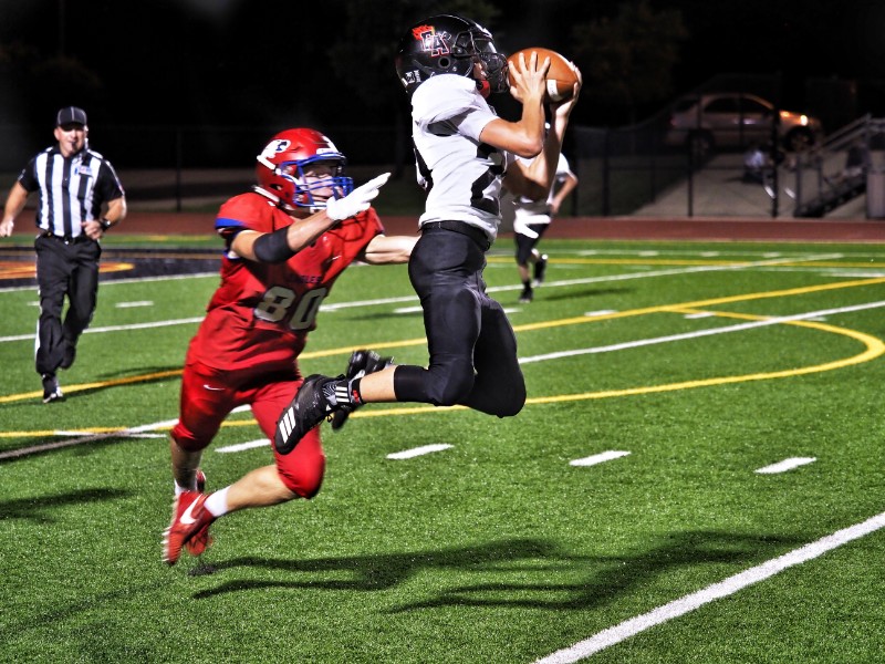 Faith Academy's Case Coleman hauls in a pass during the Flames' game against the Summit Christian Academy Eagles on Sept. 7. The Flames lost 54-6. Staff photo by Daniel Clifton