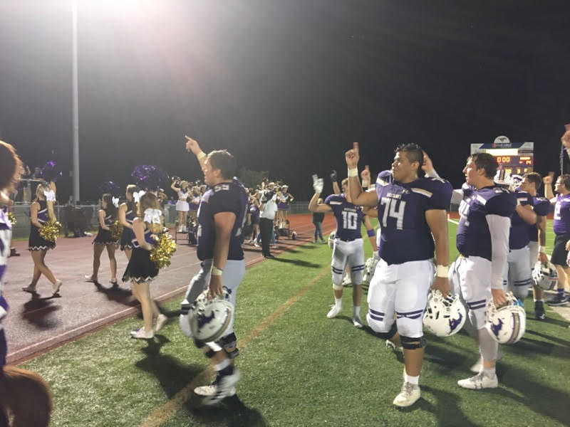 The Marble Falls High School football players walk toward the home stands to sing the school song in celebration after beating Burnet 34-14 on Sept. 7. Photo by Martelle Luedecke/Luedecke Photography