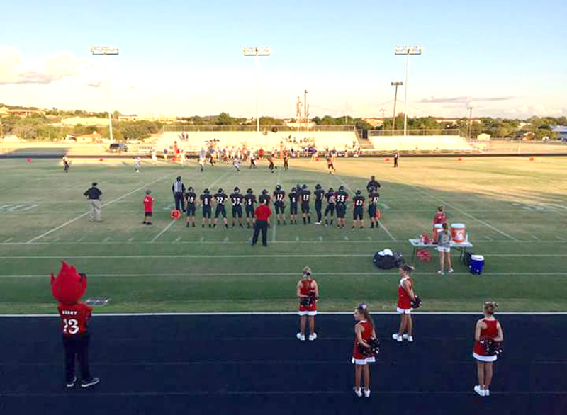 The Faith Academy of Marble Falls football team stands ready to enter the game against San Antonio Christian School of Castle Hills in the 2018 season opener. The Flames won 51-33 in their return to six-man football Aug. 30. Courtesy photo