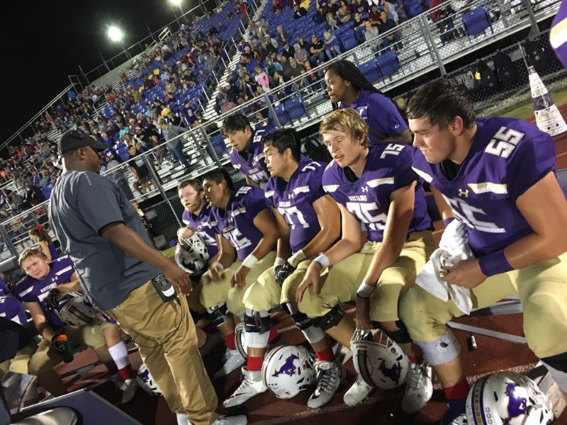 Marble Falls High School offensive line coach Cyril Lemon addressed the linemen during the Mustangs’ 20-7 win over Leander Glenn on Oct. 26. Photo by Martelle Luedecke/Luedecke Photography