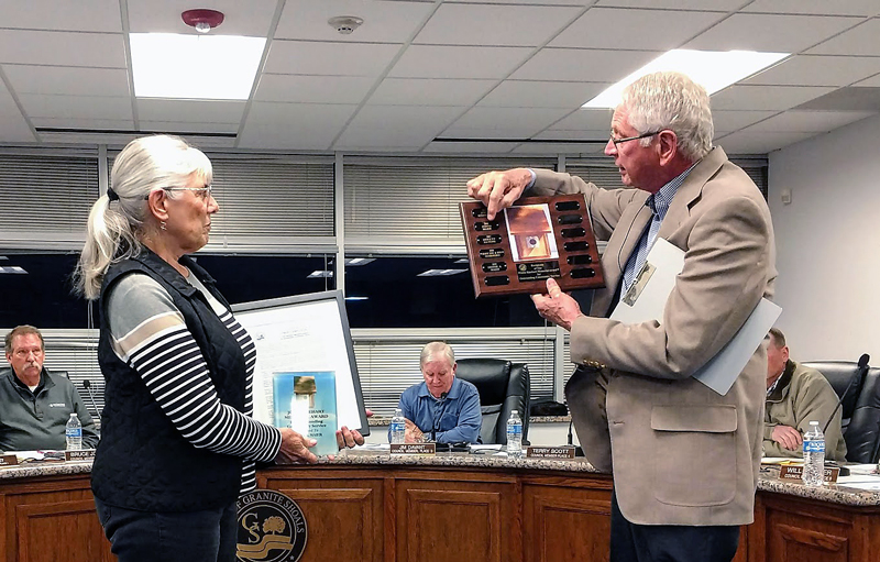 Granite Shoals Mayor Carl Brugger read the plaque honoring former city Mayor Dennis Maier, who was awarded the John Rinehard Memorial Award for Outstanding Community Service, during the City Council meeting Nov. 13. Accepting the honor was Maier’s wife, Donna. Dennis Maier died Aug. 7. Courtesy photo