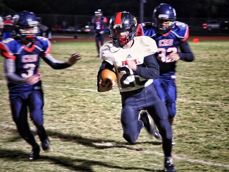 Faith Academy’s Case Coleman outran two Round Rock Christian Crusaders to the end zone for a Flames touchdown. Faith won 76-64, setting up a playoff showdown on Saturday, Nov. 17, against Amarillo San Jacinto Christian in Amarillo. Staff photo by Daniel Clifton